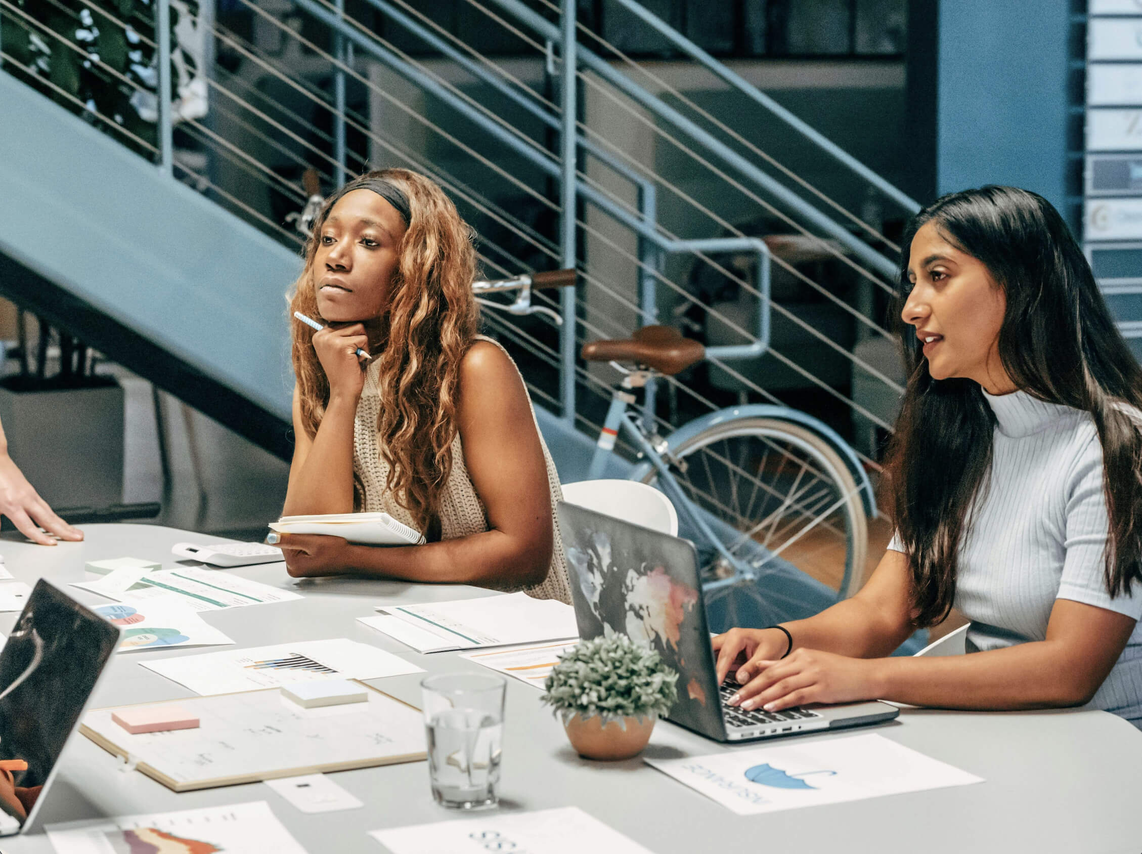 A team discussing project costs and scope around a desk