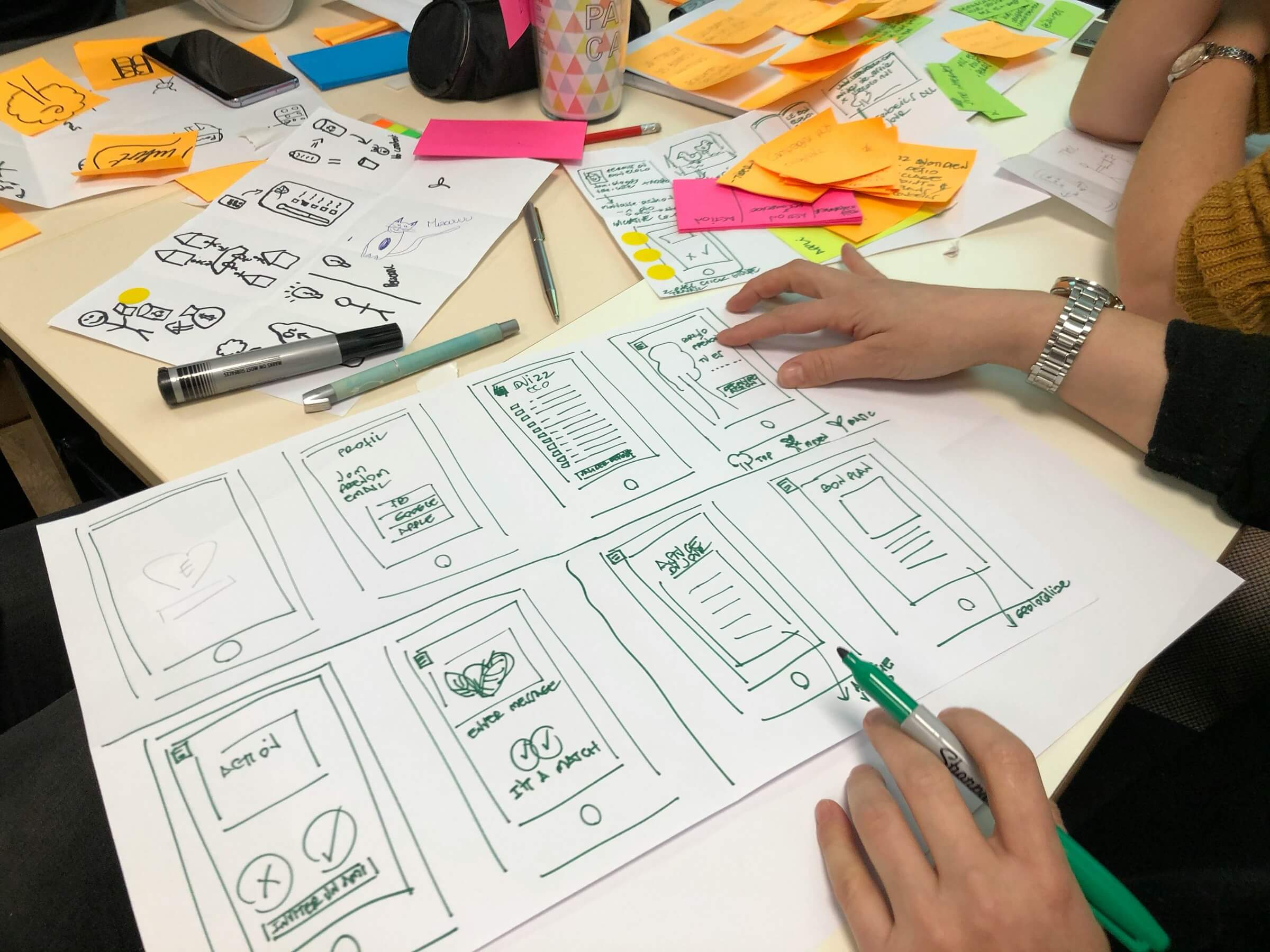 A designer sketching app wireframes by hand